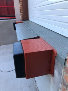 Edge of dock leveler with steel approach plate