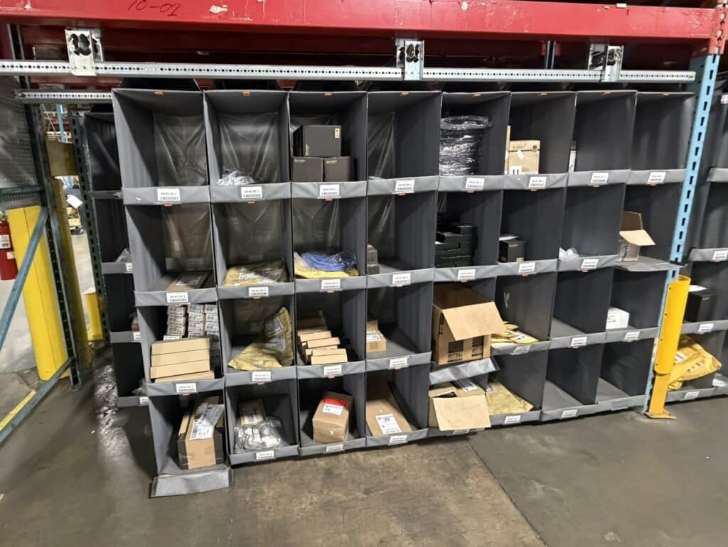 High density small parts storage system installed within warehouse pallet racking during relocation project