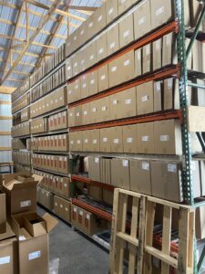 Vinyl records stored on Husky Rack & Wire teardrop pallet rack using wire decking and 24-inch deep uprights