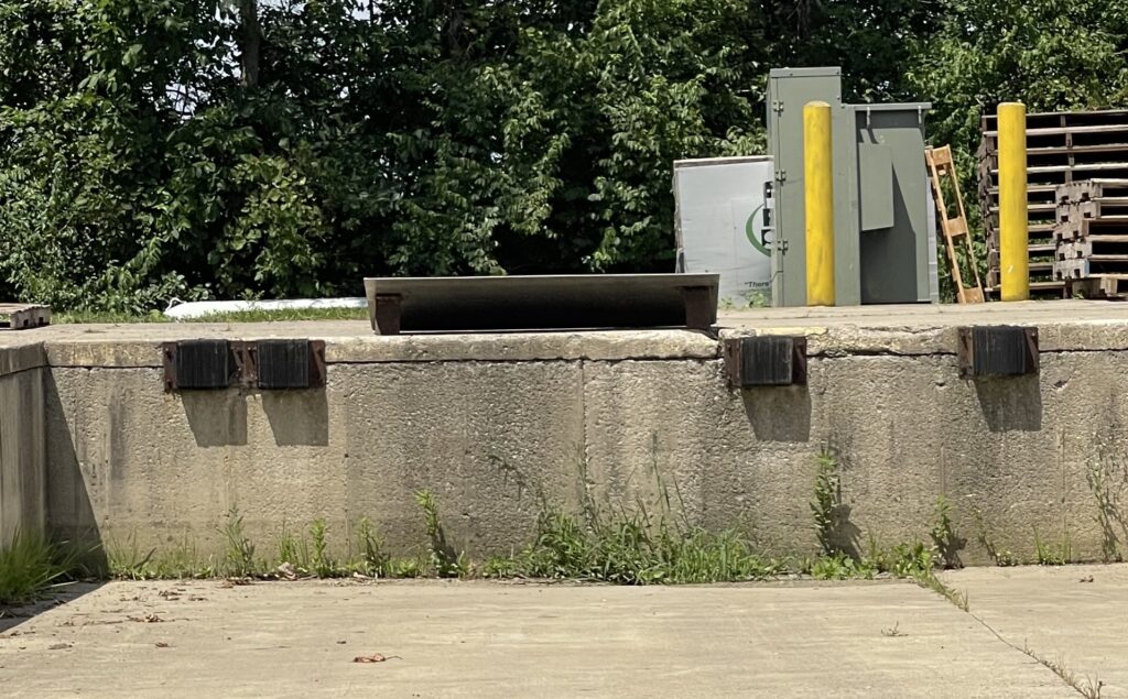 Incorrect dock bumper installation showing concrete anchors used without a welded steel connection.