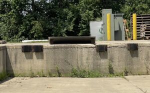 Incorrect dock bumper installation showing concrete anchors used without a welded steel connection.