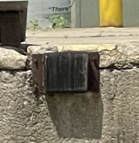 Improper loading dock bumper installation with bumpers anchored directly into the concrete dock face.