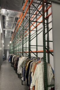 Theater costume storage area featuring pallet rack and wire deck storage