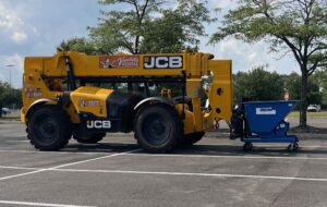 Blue self dumping hopper transporting construction debris during a school renovation project in Columbus, Ohio